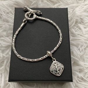 Silver woven bracelet with “i” charm